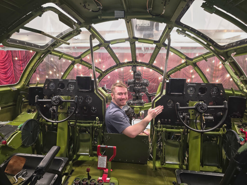 Tommy, Bluetail Team Member, sitting in the cockpit of Doc